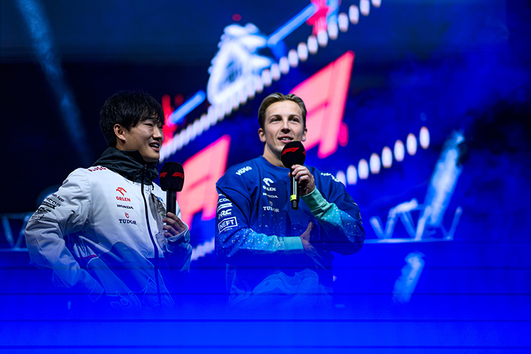 Yuki Tsunoda and Liam Lawson talk to the crowd on the fan stage before practice for the Las Vegas GP at Las Vegas Strip Circuit, November 21, 2024.