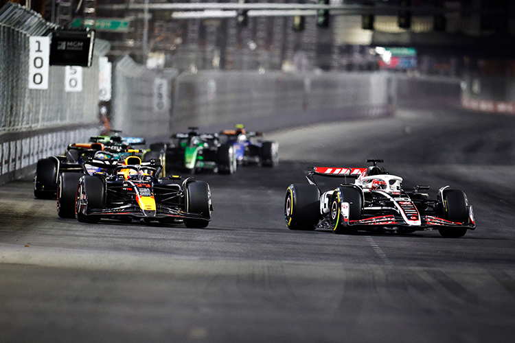 Kevin Magnussen of Denmark driving the (20) Haas F1 VF-24 Ferrari leads Sergio Perez of Mexico driving the (11) Oracle Red Bull Racing RB20 on track during the F1 Grand Prix of Las Vegas at Las Vegas Strip Circuit on November 23, 2024.